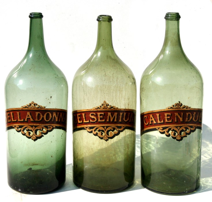 Three large glass chemist jars - Belladonna, Gelsemium and Calendula - each 61cms (24ins) high (3).