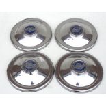 A set of four Riley chrome hub caps with central blue insignia, 23cms (9ins) diameter (4).