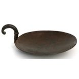 An iron skillet with scroll handle, the pan with incised decoration, 25cms (10ins) diameter.