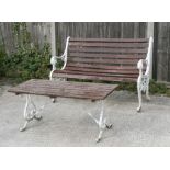 A cast garden bench with wooden slats, 125cms (49ins) wide; together with a similar garden table,