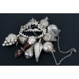 A quantity of silver coloured metal slave charms, possibly Brazilian, 339.4g total weight..