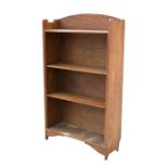 An Art Nouveau oak open bookcase with adjustable shelves, 69cms (27ins) wide.
