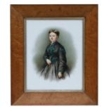 A Victorian porcelain plaque decorated a young lady wearing a black dress with green detail, in a