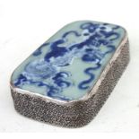 A 19th century Chinese white metal and ceramic fragment box, the celadon glazed cover painted with