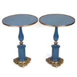 A pair of painted pedestal tables, in the French taste, with baluster columns and gilt metal mounts,