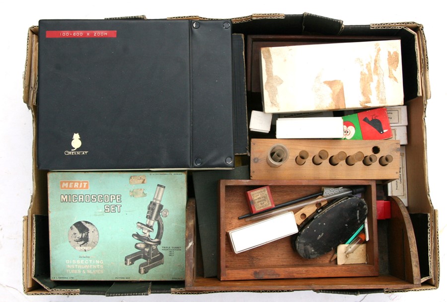 A Merrit microscope set, microscope slides and other scientific instruments.