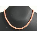 A pink coral bead necklace