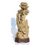 A Chinese soapstone candlestick in the form of a chrysanthemum with chickens beneath, 31cms (12.