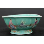 A Chinese famille rose footed bowl of octagonal form decorated with figures on a green ground, red