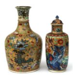 A Chinese clobbered vase and cover decorated with shi shi, phoenix and flowers on a gilded ground,