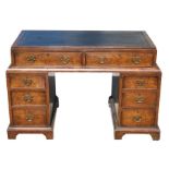 A 19th century walnut veneered kneehole desk with an arrangement of seven drawers, 117cms (46ins)