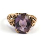 A 9ct gold ring set with a large oval amethyst, approx UK size 'I'.