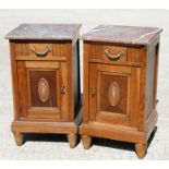 A pair of French Empire style bedside or pot cupboards with marble tops, each 40cms (15.75ins)
