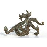 A Chinese bronze dragon holding a flaming pearl, 22cms (8.5ins) long.