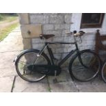 A gentleman's Raleigh bicycle with Brooks leather saddle, chain guard and dynamo.