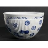 A Chinese blue & white ribbed bowl decorated foliate roundels, 15cms (6ins) high.Condition