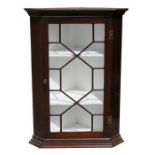 A 19th century mahogany corner cupboard with astragal glazed door, 74cms (29ins) wide.