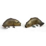 A pair of Japanese bronze wall pockets in the form of carp, 20cms (8ins) high.