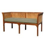 A Bergere three-seater sofa with double caned sides and back, 170cms (67ins) wide.
