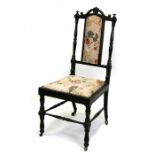 A 19th century ebony occasional chair with drop-in upholstered seat, on turned front supports joined