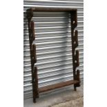 A wall mounted walnut three-gun gun and whip rack, 77cms (30.25ins) wide.