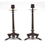 A pair of Regency style bronze and gilt brass candlesticks with dished drip pans, reeded columns and