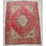 A large caucasian rug with geometric patterns within a multi border,