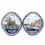 A Delft style wall plaque decorated with figures in a boat, 33cms (13ins) diameter; together with