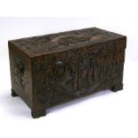 A Chinese camphorwood chest heavily carved with figures and foliage, 104cms (41ins) wide.