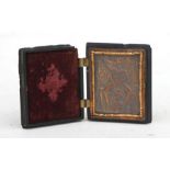 An erotic bronze panel housed in a moulded union case, 4.5 by 6cms (1.75 by 2.25ins).