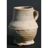 A late 15th / early 16th century Tudor period German salt glaze drinking mug with fluted base, 13.