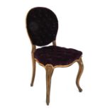 A Victorian gilded boudoir chair with button upholstered seat and back, on cabriole front supports.