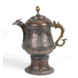 A large Middle Eastern silvered copper coffee pot decorated with foliate scrolls, 35cms (13.75ins)