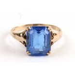 A 9ct gold dress ring set with a square blue stone, approx UK size 'L'.