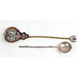 An Islamic white metal spoon with turquoise cabochons; together with a similar spoon with enamel