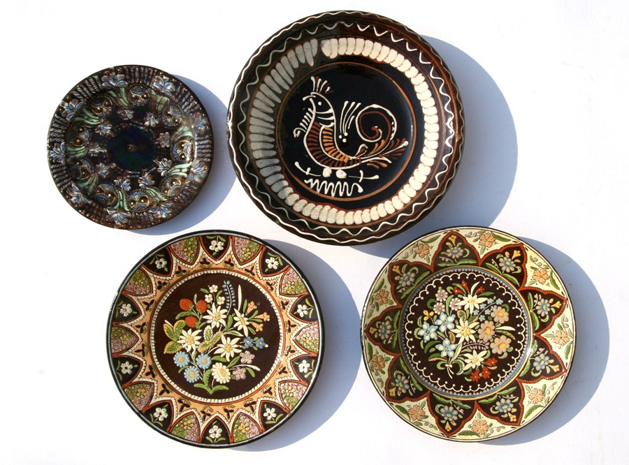 A group of Thoune pottery plates and bowls, the largest 26cms (10.25ins) diameter.