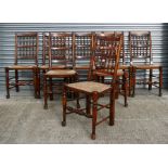 A set of eight stained beech kitchen or dining chairs with turned spindle backs, brush seats and