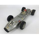 A RICO Ferrari F1 GP tin plate friction drive car, with racing legend Fangio at the wheel, featuring