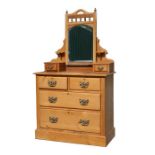 A pine dressing chest, the superstructure having a central mirror flanked by two drawers, on two