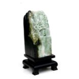 A Chinese green figured jade / hardstone boulder depicting figures in a landscape, 13cms (5ins)