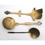 A Victorian brass cream skimmer and two others (3).