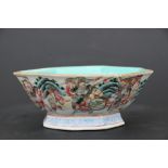 A Chinese famille rose footed bowl of octagonal form decorated with warriors, red seal mark to the