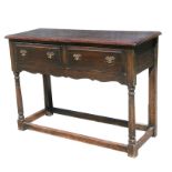A 19th century oak dresser base with two frieze drawers, on turned column front legs joined by