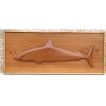 A Pitcairn Island style half fish depicting a shark mounted on a pitch pine panel, overall 71 by