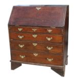 A 19th century oak bureau with fall-front flap revealing a fitted interior above four long graduated