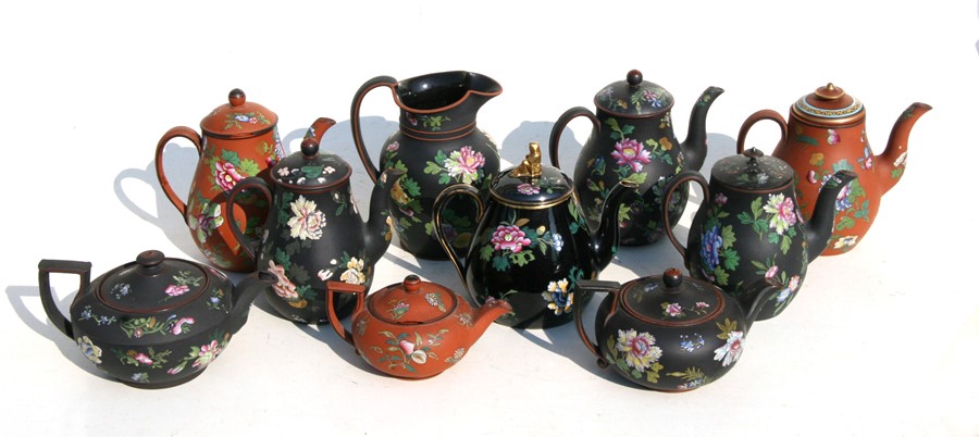 A large quantity of Wedgwood Antico Rosso teapots decorated with enamelled Chinese flowers.Condition