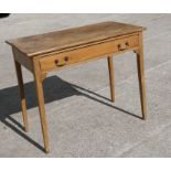 A pine side table with single frieze drawer, on tapering square legs, 91cms (36ins) wide.