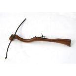 An 18th century style Italian crossbow with walnut stock, 76cms (30ins) long.