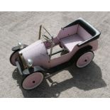 A child's pedal car in the form of an Edwardian motor car.