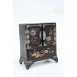 A late 19th century Japanese lacquer table cabinet, 24cms (9.5ins) wide.